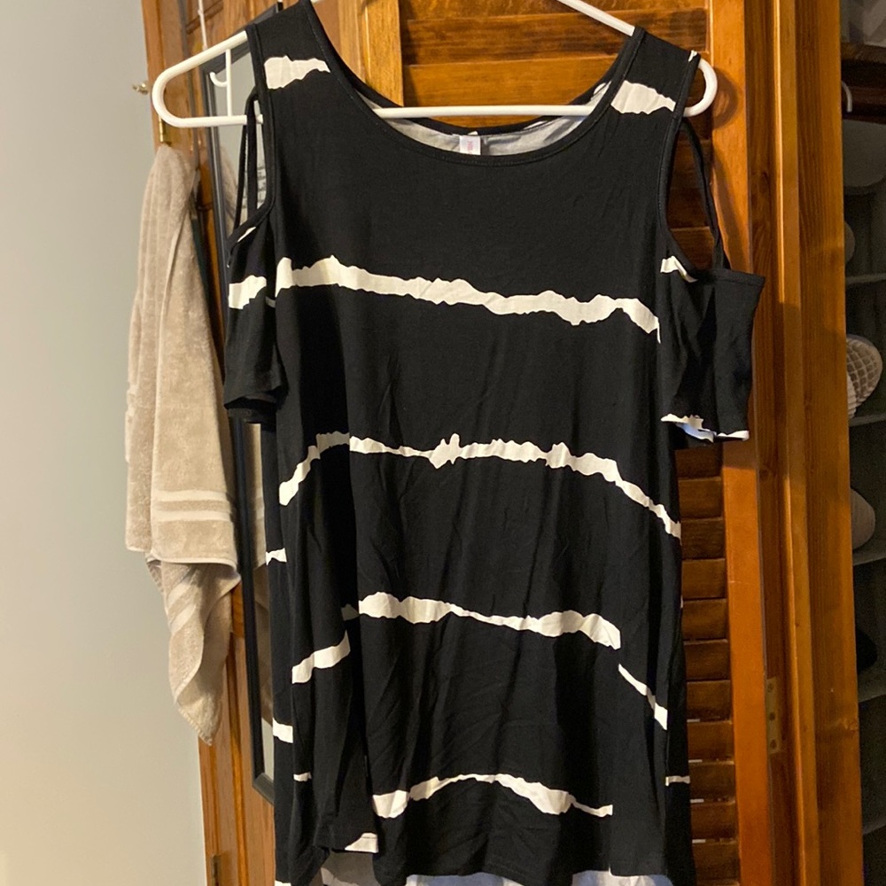 Black and white tunic with shoulder showing design.